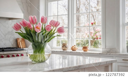 vase of fresh pink tulips on a pristine marble countertop adds a touch of elegance and spring freshness to a sunlit, modern kitchen with large windows vase of fresh pink tulips on a pristine marble countertop adds a touch of elegance and spring freshness to a sunlit, modern kitchen with large windows 122787392