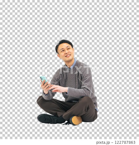 A middle-aged man in casual wear sitting and using a smartphone. A transparent full-body photo PNG precisely cut by hand 122787863