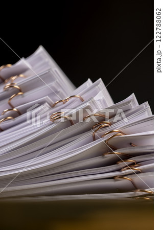white blank sheets of paper connected by copper staples 122788062