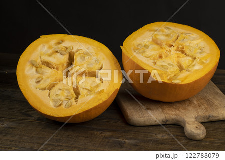 ripe orange pumpkin with seeds cut into pieces 122788079