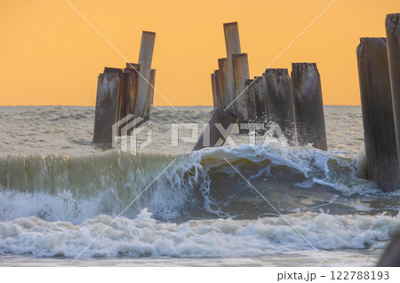 A beautiful sunrise at Sao Eang Beach (Old leaning cement pillars) Cha-Am beach is a famous about a lot of old leaning cement pillars of the pier located in Cha-Am beach Phetchaburi Thailand 122788193