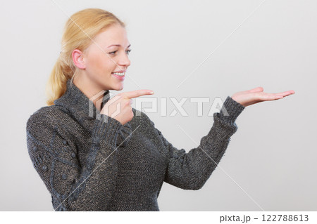 Happy woman pointing on right side Happy woman pointing on right side 122788613
