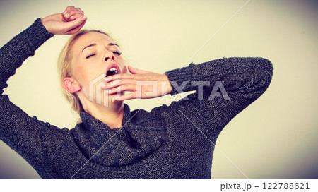 Sleepy, tired, yawning woman stretching arms Sleepy, tired, yawning woman stretching arms 122788621