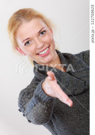 Happy woman looking at camera greeting Happy woman looking at camera greeting 122788628