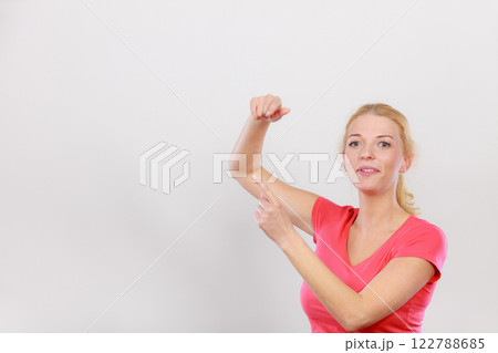 Happy woman pointing on left side 122788685