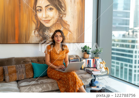 portrait of a specialist in a cozy environment working on a laptop, art gallery or modern office portrait of a specialist in a cozy environment working on a laptop, art gallery or modern office 122788756