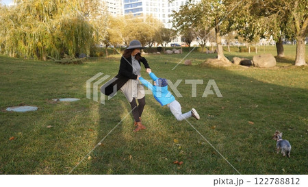 Happy mom and son playing in a spring park together 122788812