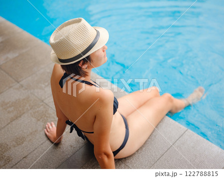 Young woman relaxing by the pool at a Kuala Lumpur hotel 122788815