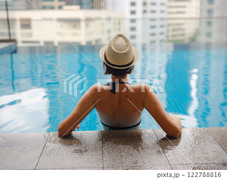Young woman relaxing by the pool at a Kuala Lumpur hotel 122788816