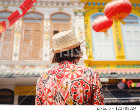 woman in dress and hat exploring vibrant streets of Malacca, Malaysia. woman in dress and hat exploring vibrant streets of Malacca, Malaysia. 122788824