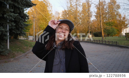 Portrait of a beautiful happy woman in spring in a city park 122788936