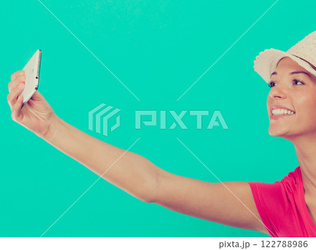 Woman taking picture of herself with phone 122788986
