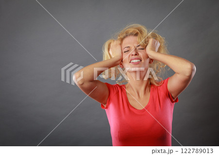 Stressed, frustrated, depressed young woman in pain Stressed, frustrated, depressed young woman in pain 122789013