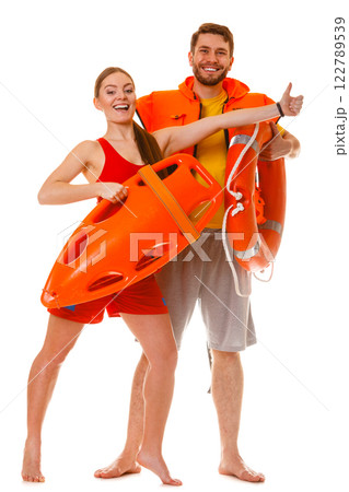 Lifeguards with rescue ring buoy and life vest. Lifeguards with rescue ring buoy and life vest. 122789539