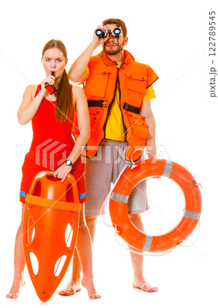Lifeguards in life vest with ring buoy whistling. Lifeguards in life vest with ring buoy whistling. 122789545