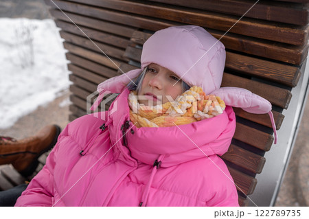 Cozy Moments of Winter A Child Wearing an Adorable Pink Puffer Jacket in the Snowy Landscape 122789735