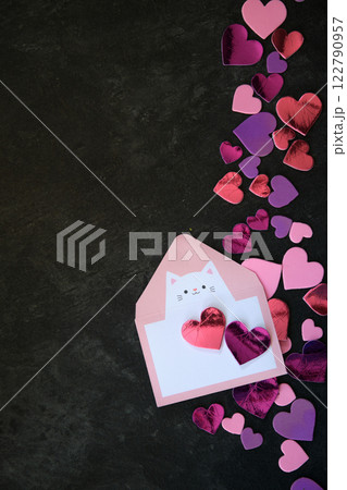 multicolored hearts on dark background and envelope 122790957