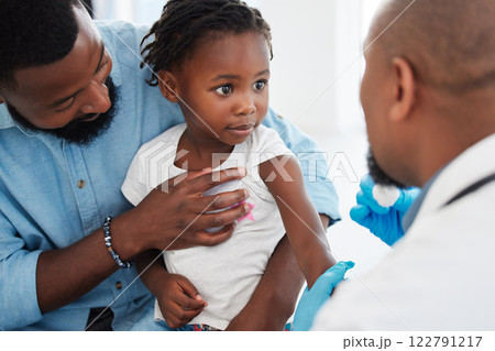 Father, child in consultation with pediatrician doctor for medical healthcare, insurance and trust. Black people, girl and men consulting appointment in hospital clinic for kid or toddler vaccination 122791217