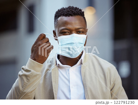 Happy end of covid, with businessman removing face mask in urban city with vision, goal for success after covid 19. Smile, trust and leadership portrait of corporate worker post covid or corona virus 122791230