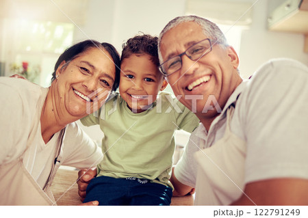 Grandparents, grandkid and family smile, happy and playing together at home. Portrait face of love, bond and relaxing elderly grandma, grandpa and young kid for funny, care and childhood development 122791249