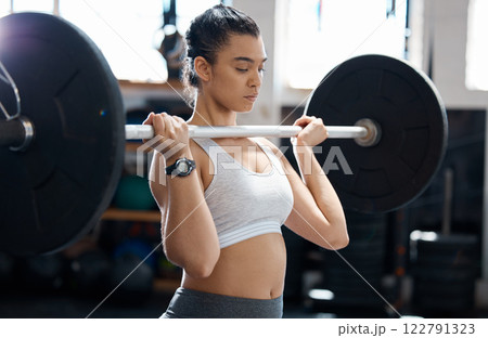 Fitness, workout and exercise woman with barbell in gym for health, cardio and wellness. Strength, sports and healthy bodybuilder or athlete training for weight power lifting and muscle competition Fitness, workout and exercise woman with barbell in gym for health, cardio and wellness. Strength, sports and healthy bodybuilder or athlete training for weight power lifting and muscle competition 122791323