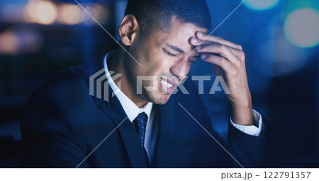 Headache, stress and burnout with businessman working late night in corporate office building. Anxiety, mental health and migraine pain with audit, tax or risk company employee sitting at desktop 122791357