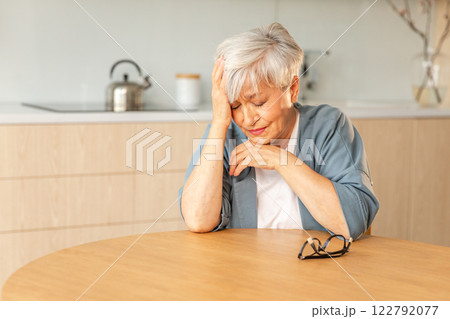 Sad tired ill sick lonely disappointed older senior woman sitting at home alone. Unhappy mature grandmother experiencing grief relative death bad news. Stressed elder lady suffering from loneliness Sad tired ill sick lonely disappointed older senior woman sitting at home alone. Unhappy mature grandmother experiencing grief relative death bad news. Stressed elder lady suffering from loneliness 122792077