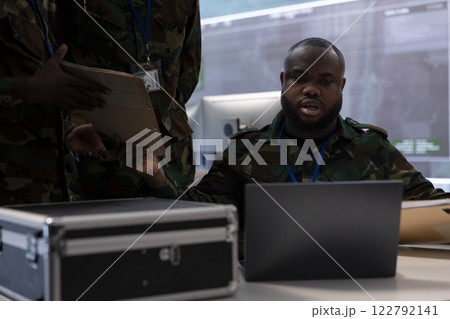 Government army experts in advanced command post overseeing surveillance activity, coordinate security protocols and collect real time data for field military missions. Control tower. Government army experts in advanced command post overseeing surveillance activity, coordinate security protocols and collect real time data for field military missions. Control tower. 122792141