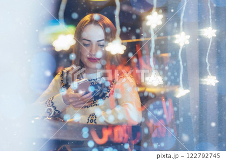 Young beautiful woman sitting in cafe, drinking coffee. Christmas, new year, Valentines day, winter holidays concept 122792745