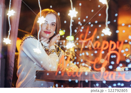 Young beautiful woman sitting in cafe, drinking wine. Christmas, new year, Valentines day, winter holidays concept Young beautiful woman sitting in cafe, drinking wine. Christmas, new year, Valentines day, winter holidays concept 122792805