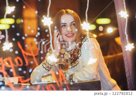 Young beautiful woman sitting in cafe, drinking wine. Christmas, new year, Valentines day, winter holidays concept Young beautiful woman sitting in cafe, drinking wine. Christmas, new year, Valentines day, winter holidays concept 122792812