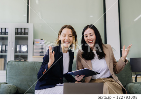 Business team creative are excited business success with inspiration from their excellent financial results that are happy working in a modern office on a computer. 122793008