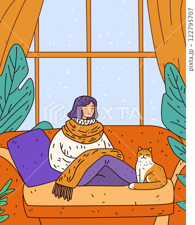 Cozy winter scene woman relaxing home warmth. A woman in a sweater and scarf sits on a couch with a cat by her side in a room with large windows and plants 122795707