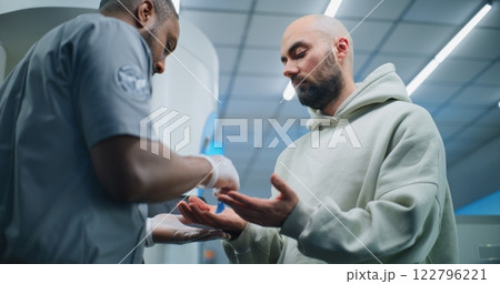 Airport Security Checkpoint: Security Officer Doing TSA Hand Swab Screening to Adult Man 122796221