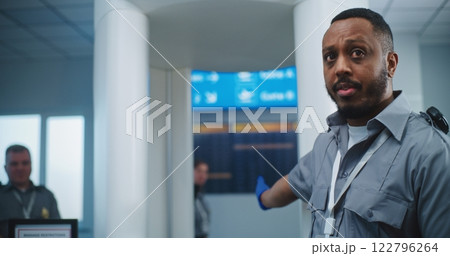 Security Officer Instructs Diverse People About TSA Screening Procedures for Boarding Flight Security Officer Instructs Diverse People About TSA Screening Procedures for Boarding Flight 122796264