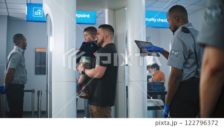 Airport Security Checkpoint: Family with Kids Passing Through Metal Detector Scanner Gates Airport Security Checkpoint: Family with Kids Passing Through Metal Detector Scanner Gates 122796372