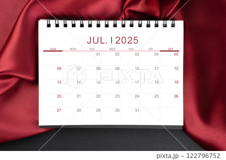 July 2025 Monthly desk calendar with red silk on black leather background. July 2025 Monthly desk calendar with red silk on black leather background. 122796752
