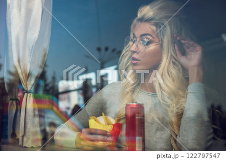 Stylish Woman Eating Snack 122797547