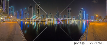 Panoramic night view of Dubai Marina skyline with waterfront reflections Panoramic night view of Dubai Marina skyline with waterfront reflections 122797615