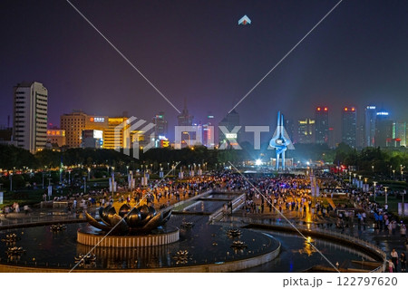Illuminated fountain show at Quancheng Square in Jinan China with crowds at night 122797620