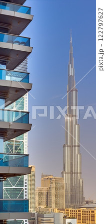 Burj Khalifa against a clear blue sky with modern architecture in the foreground 122797627