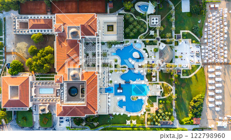 Aerial view of a luxury resort with elegant architecture and stunning pools. Aerial view of a luxury resort with elegant architecture and stunning pools. 122798960