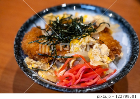 Katsudon, a popular Japanese food. It is a bowl of rice with fried pork cutlet, egg and vegetables Katsudon, a popular Japanese food. It is a bowl of rice with fried pork cutlet, egg and vegetables 122799381