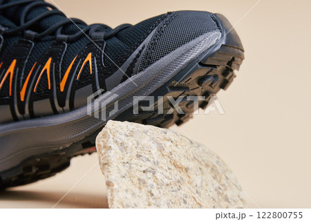 Black Hiking Boot on Small Rocks in Studio Black Hiking Boot on Small Rocks in Studio 122800755