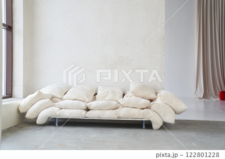 A creative composition of the living room interior with an uneven sofa made of pillows in a modern style. Home decor. With space to copy. High quality photo 122801228