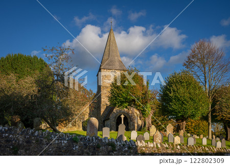 Burwash, East Sussex, UK: St Bartholomew's Church in Burwash with cemetery, trees and wall. 122802309