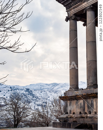 cloudy sky over mountains and Garni Temple columns 122802549