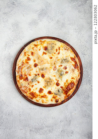 Freshly baked cheese pizza, white pizza, on a wooden plate, homemade, no people, Freshly baked cheese pizza, white pizza, on a wooden plate, homemade, no people, 122803062