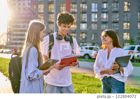 Group of college students talking with female teacher coach mentor, outdoor 122804072
