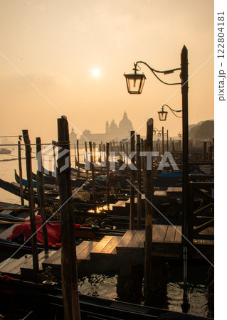 Experience the serene beauty of the Sunrise at Venetian Gondola Dock in Venice Experience the serene beauty of the Sunrise at Venetian Gondola Dock in Venice 122804181